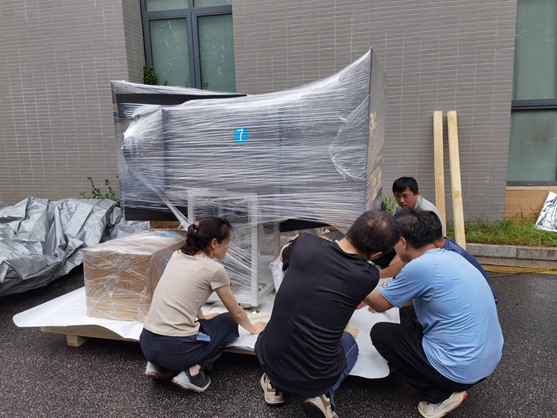 Figure 3. The team checks every packing detail to keep the equipment secure throughout long-distance transport