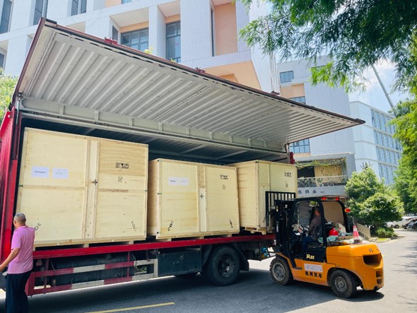 Crated equipment being loaded for shipment